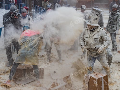 Preview: Ibi, Spain - December, 28 2018: People throwing eggs and flour at each other