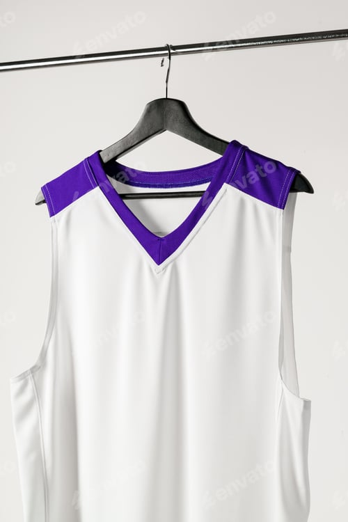 Preview: White basketball jersey hanging against white background