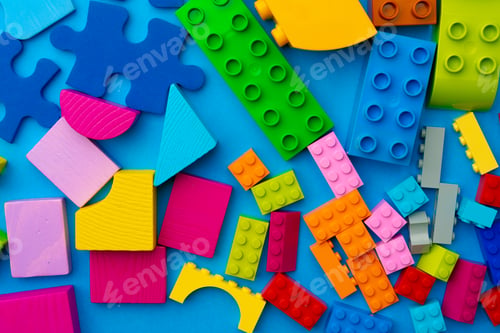 Preview: Multicolored pieces of toy constructor on blue background