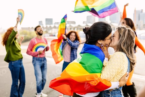 Preview: Lesbian couple kissing on LGBTQ parade festival. Two young girlfriends in love.