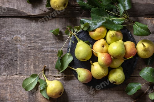 Preview: Organic healthy juicy ripe pear on a wooden kitchen table.