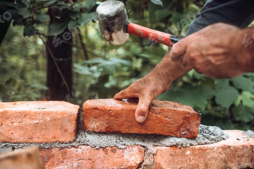 Preview: Construction bricklayer worker building with bricks, mortar, trowel and rubber hammer