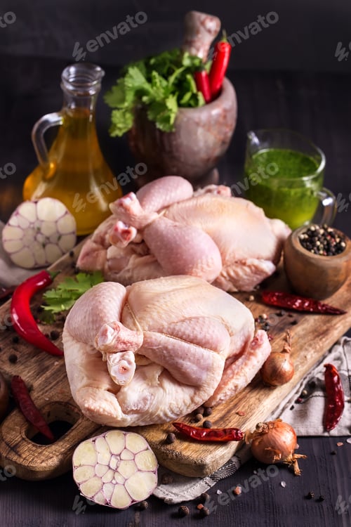 Preview: Raw Chicken with Herbs and Spices on Wood