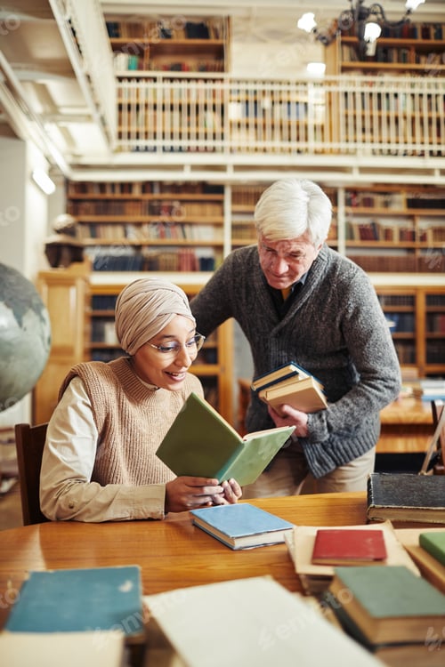 Preview: Senior Professor Helping Student in Library