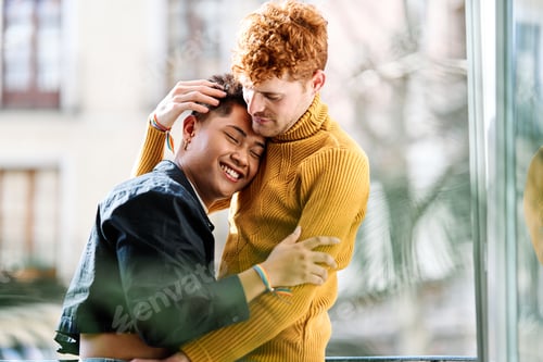Preview: Happy multiethnic gay couple embracing at home