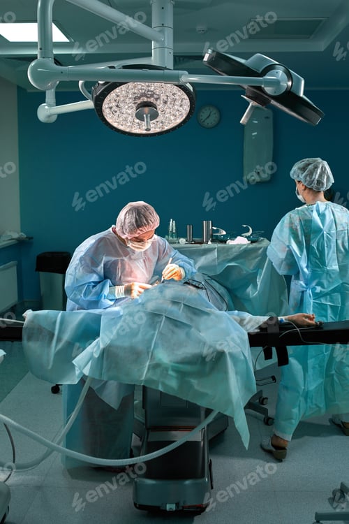 Preview: Group of surgeons in operating theater. Medical team performing surgery in operation room.