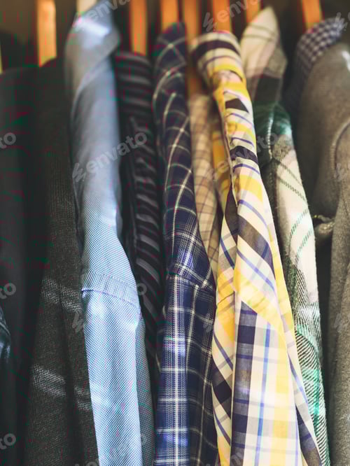 Preview: Neatly Arranged Shirts Hanging in a Closet