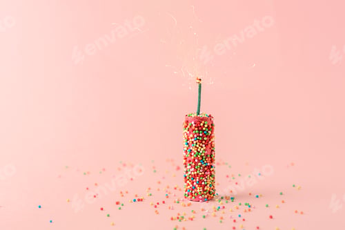 Preview: Creative concept of the holiday. Pink firecrackers with sweet balloons on a pink background.