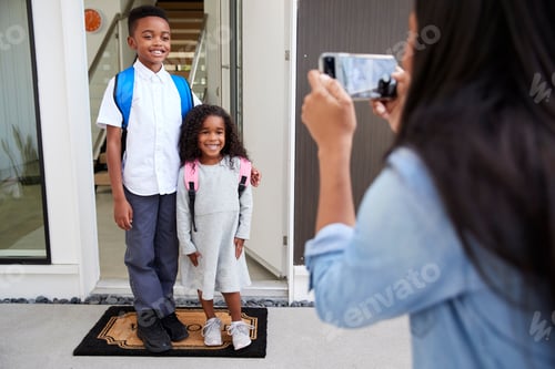Preview: Mother Taking Photo Of Children With Cell Phone On First Day Back At School