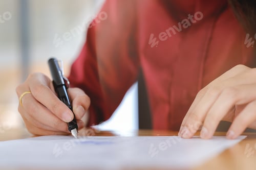 Preview: Businesswoman signing a contract document making a deal.