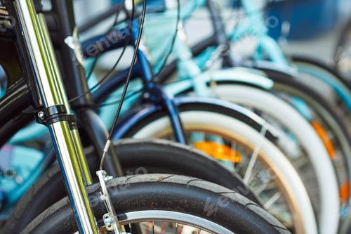Preview: Wheel detail of a group of bicycles on parking
