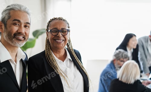 Preview: Multiracial business people smiling on camera while working inside bank office