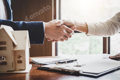 Preview: Real estate agent and customers shaking hands together celebrating finished contract after about