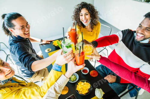 Preview: Multiracial friends wearing face masks drinking cocktails at bar restaurant
