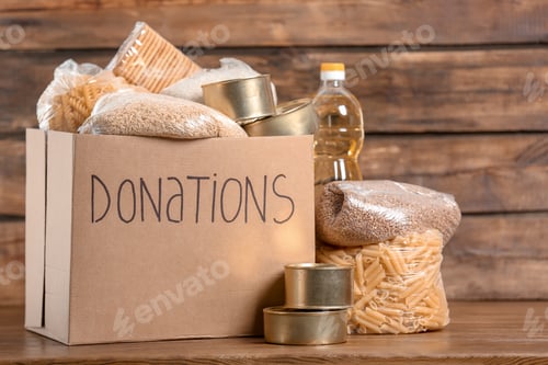 Preview: Donation box with food on wooden background
