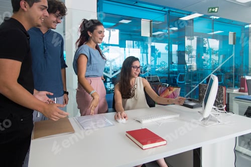 Preview: Young people smiling and surprised watching a computer at work