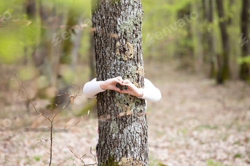 Preview: Young generation embracing nature, with a hug at a tree