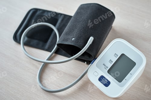 Preview: Digital blood pressure monitor on the table, closeup. Helathcare and medical concept