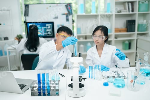 Preview: Medical research teamwork in laboratory using microscope and blood test tubes for DNA analysis