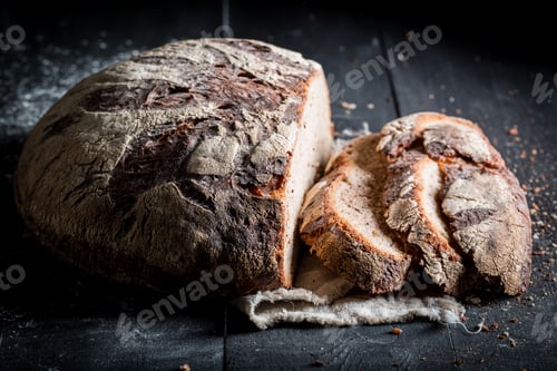 Preview: Healthy sliced loaf of bread for breakfast on dark table