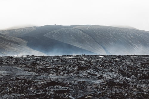Preview: Dramatic view of still hot lava rocks and steam rising from the hot grounds