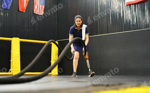 Preview: Young female with one prosthetic leg with doing arm and shoulder exercises
