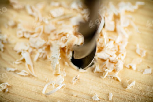 Preview: Piece of wood is drilled with shavings.