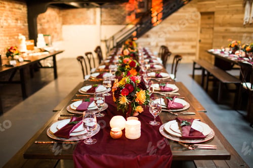 Preview: Long table with luxury plates and decorated with colorful flowers and candles