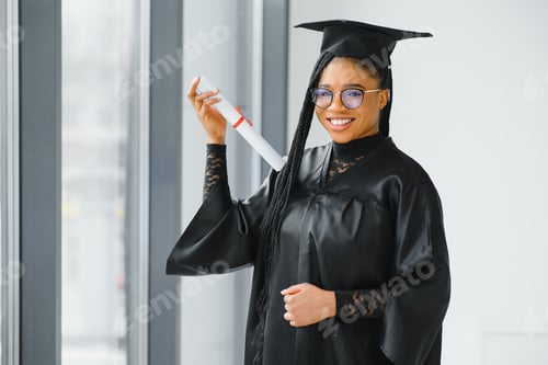Preview: happy african american female student with diploma at graduation