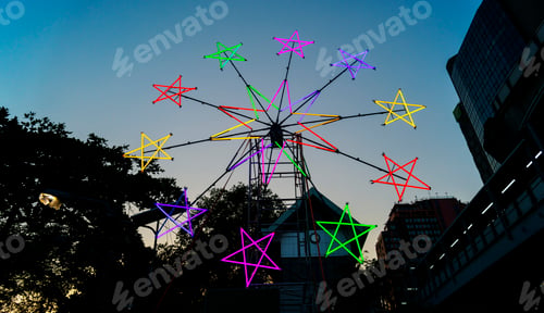 Preview: Star shaped neon windmill in a festival