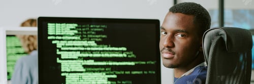 Preview: Young Black Cybersecurity Worker Looking At Camera Website Header