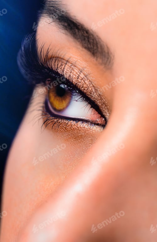 Preview: Closeup of a woman's brown eye with a vivid makeup