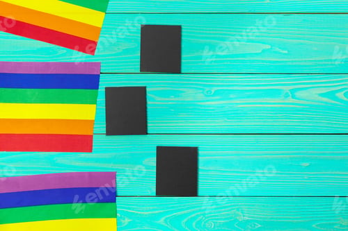 Preview: Bright rainbow gay flag on wooden background and blank space