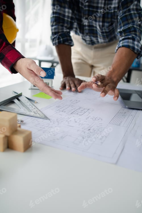 Preview: The home design architects are reviewing the house plan draft, the project commissioned by the clien