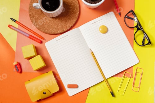 Preview: Writing tools and a drink arranged on a colorful workspace table