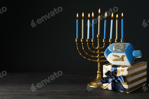 Preview: Hanukkiah, gingerbread and gift box on black background, space for text