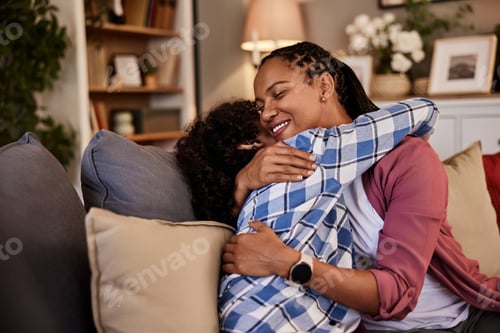 Preview: Affectionate loving middle-aged mother cuddling teenage child, excited by good news.