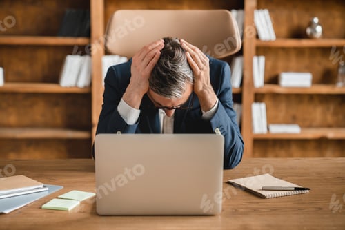 Preview: Freelancer having working problems deadline headache migraine, fired in office working on laptop