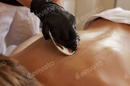 Preview: Massage Therapist Performing IASTM Metal Scraping Technique for Myofascial Release, Sports Recovery