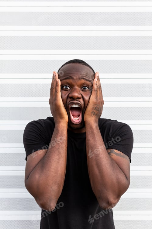 Preview: Amazed black man screaming near striped wall