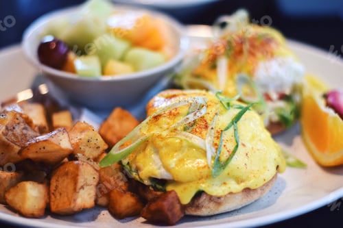 Preview: Eggs Benedict with roasted potatoes and a fruit salad