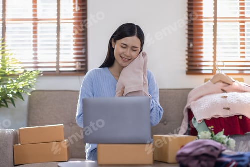 Preview: Portrait young attractive hipster asia female owner startup work happy with box at home prepare