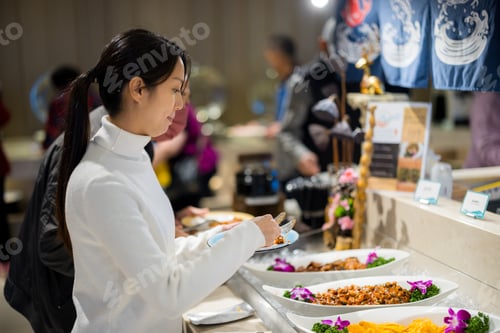 Preview: Asian woman have buffet at restaurant