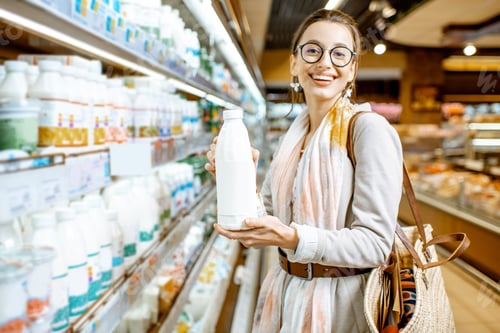 Preview: Woman buying milk in the supermarket
