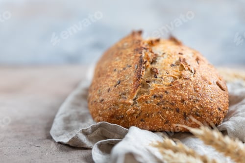 Preview: Loaf of artisan sourdough bread with wheat ears and linen napkin