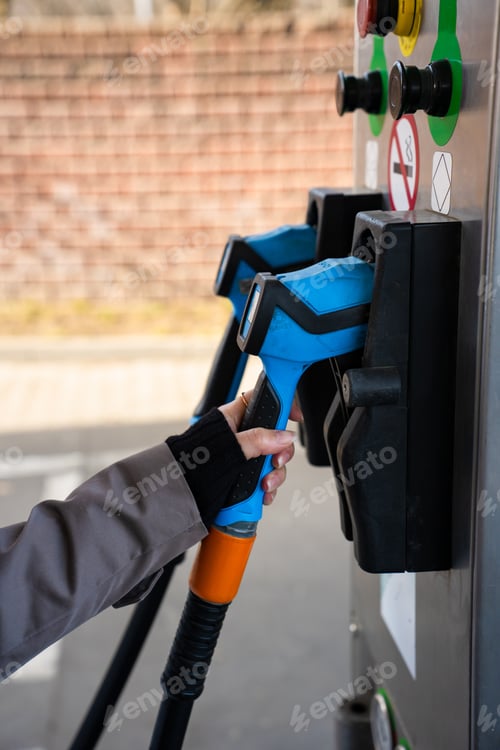 Preview: Driver refilling automobile with LPG fuel using gas station nozzle