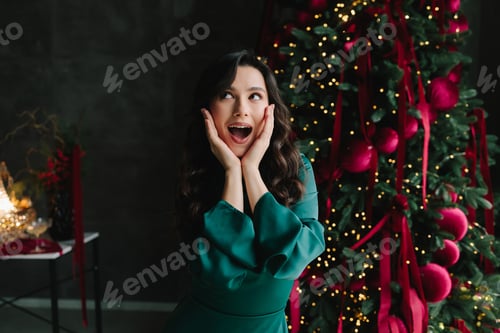 Preview: Surprised woman reacts with delight, celebrating Christmas and New Year with festive decorations.