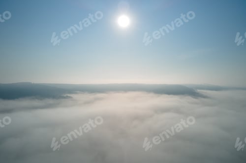 Preview: Aerial view from high altitude of earth covered with white puffy cumulus clouds on sunny day