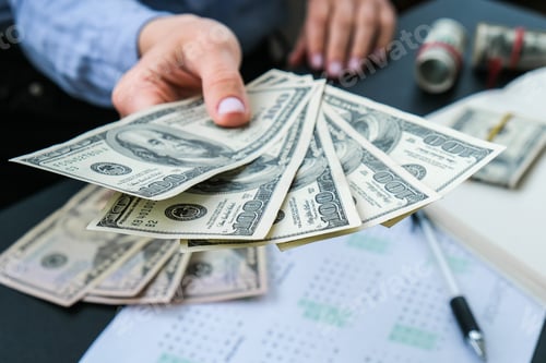 Preview: Business Woman Displaying a Spread of Cash US dollars. Close-up. Income and Business concept. Venali