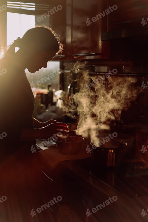 Preview: young woman cooking in the kitchen